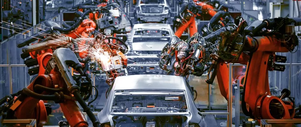 robots in a assembly line on a car factory