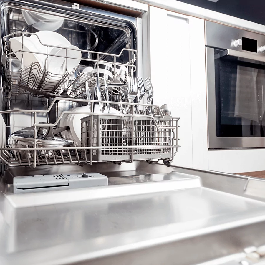 a dishwasher with the door open and full of kitchen utensils